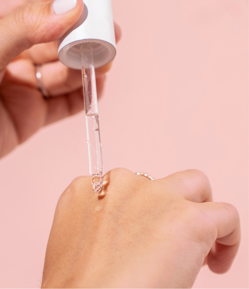 A person using a serum dropper on their hand. O Cosmedics offers a range of corrector serums to address every skin condition and concern.

